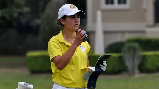 Violeta Fernandez-Tagle brings up her range finder while check out her yardage book on the par 3 15th
