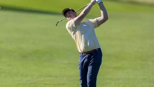 Paul Conroy poses as he follows his iron shot at the Western Intercollegiate