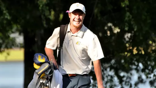 John Houk has a laugh with a competitor walking to the next tee at the 2023 SoCon Championships