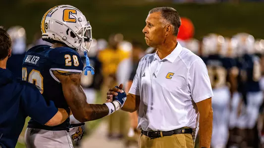Jordan Walker & Coach Rusty Wright share a congratulatory hand shake after a big defensive stop late in the win over Kennesaw State