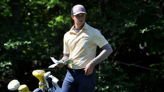 Garrett Engle checks his yardage book in the final round of the SoCon Championships