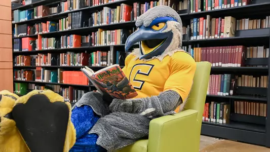 Scrappy puts his feet up and reads in the library