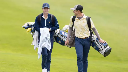 Braedon Wear and Garrett Engle share a laugh walking down the fairway at the 2023 Western Intercollegiate