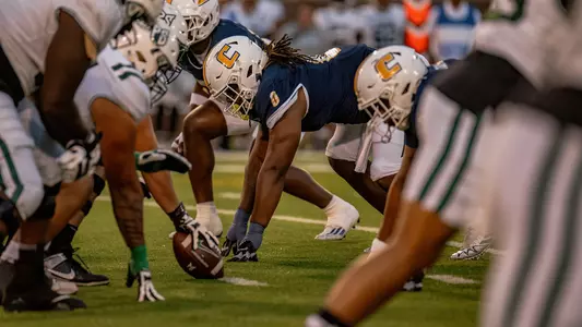 Quay Wiggles is positioned in a 4-point stance waiting for the snap against Portland State
