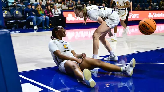 Brooke Anya celebrates with Karsen Murphy from the floor after making a layup and earning the And-1.