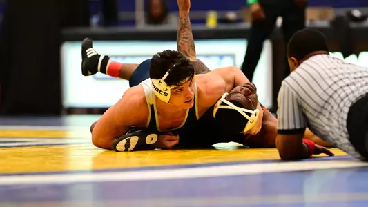 Kamdyn Munro looks to the official as he tries to pin his Campbell opponent before the buzzer ends the period