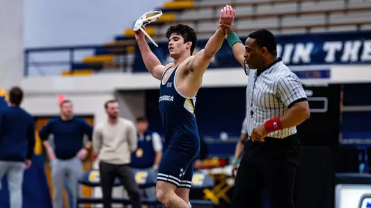 Kamdyn Munro raises his hands in victory after dominating performance against Campbell