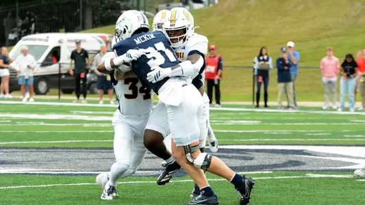 The Mocs defense swarms Samford's ball carrier in the 2025 win in Birmingham
