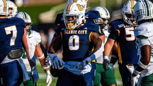 Ryan Ingram flexes after bulling his way to a first down against Stetson
