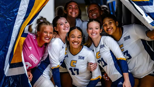 The Mocs peek out of the tunnel hamming it up for the camera before the UNCG match
