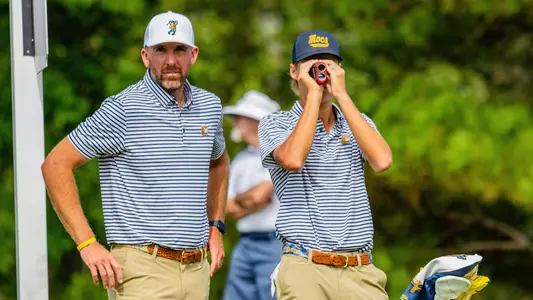 Blaine Woodruff and Evan Rogers check yardage and prepare for par 3 approach