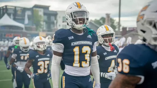 Beni Mwamba excitedly takes the field with his teammates prior to the game with Mercer