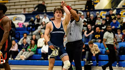 Dayne Dalrymple's hand is raised following his 1st career ranked win in the 2025 dual vs Campbell