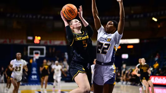 Sigrun Olafsdottir drives to the basket beginning her layup against UNCG