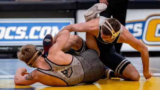Eli Knight works on the mat to complete takedown in win over Greyson Clark of Purdue