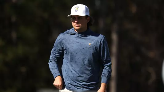 Ethan Whitaker stares intently greenside waiting his turn to putt at Briar's Creek