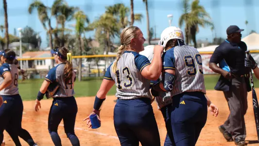 Presley Williamson congratulated by Baileigh Pitts after home run