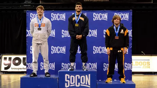 Noah Castillo towers in the center of the SoCon Championships podium winning the title at 157.
