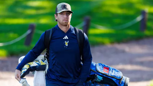 Dalton Chuba carries his bag to the next tee at Kentucky