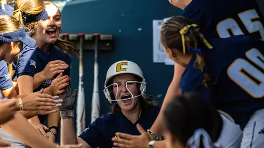 Lexi Cooley celebrates with teammates in dugout