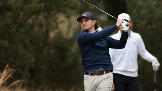 Ethan Whitaker follows his shot with a competitor looking on at the Donald Ross Collegiate.