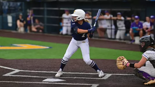 softball player in a stance to hit the ball.