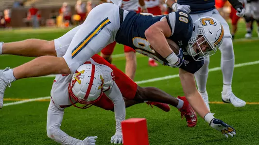 John McIntyre fights through a tackle stretching to reach the end zone in the 2024 win over VMI