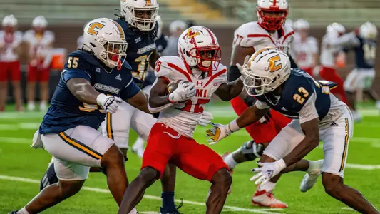 Ky Tayo and Kam Baah-Slay converge on a VMI ball carrier