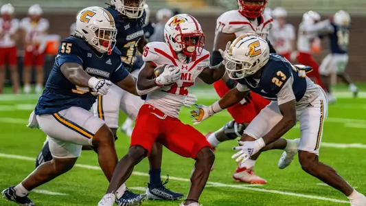 Ky Tayo (55) & Kam Baah-Slay (23) converge on VMI ball carrier in the runaway 2024 win