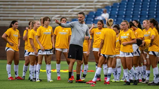 Head coach Gavin McKinney with team