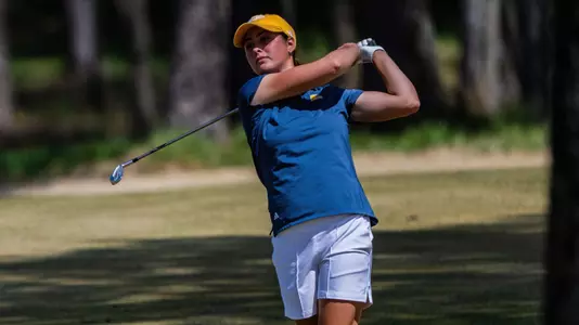 Chloe Stevanazzi poses as she follows her iron shot approach to the green