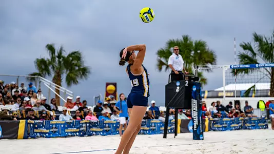 Corina Vale serving the ball in the NCAA Tournament First Round against Stanford