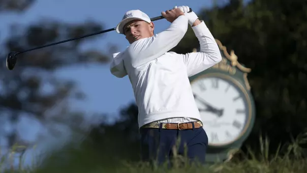 Griffin Law completes his drive with an exquisite clock tower in the background at Pasatiempo Golf Club