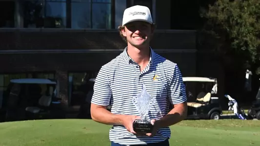 Ward Harris smiles broadly as he holds the Qubein Cup trophy after his first collegiate win.