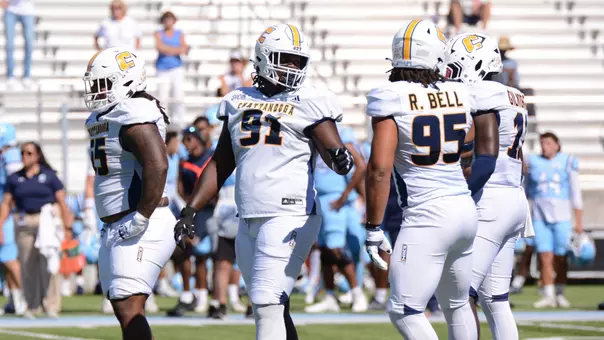 Montrell Henderson looks over his shoulder to talk alignment with defensive ends Ryan Bell & Jestin Gilmore between snaps at The Citadel.