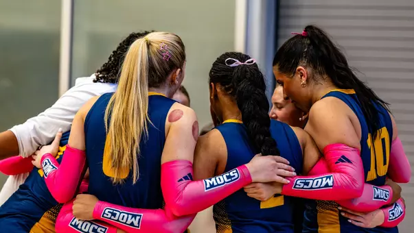 Mocs observing a pregame huddle