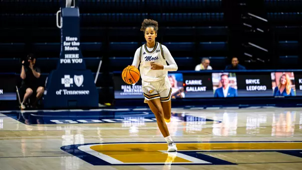 Sarah Owona dribbles the ball up the court