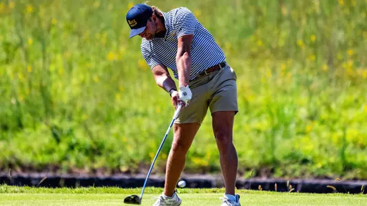 Ward Harris makes contact on his drive at the Honors Course