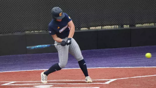 A softball player gets a hit.