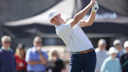 Griffin Law is finishing his swing as he levels his stare at his ball tracking the fairway