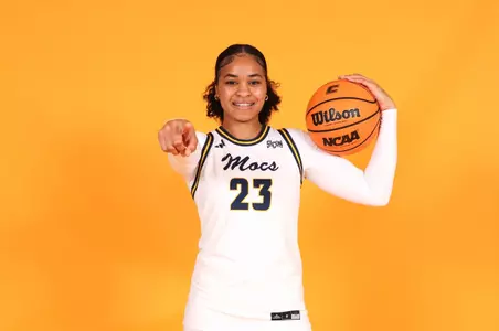 TaTianna Stovall taking a photo in a Mocs jersey on her visit to UTC
