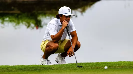 Aidan Cohl reads his putt pond side at the Honors Course