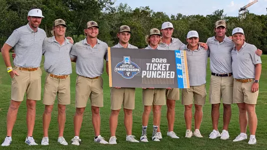 Men's golfers pose with a ticket punched sign after securing advancement to the NCAA Finals in Bryan, Texas