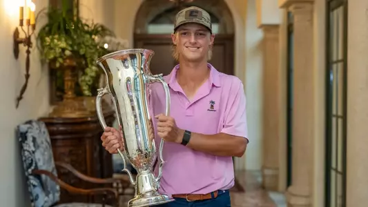 Evan Rogers proudly hoists the Georgia Am Trophy with a broad smile