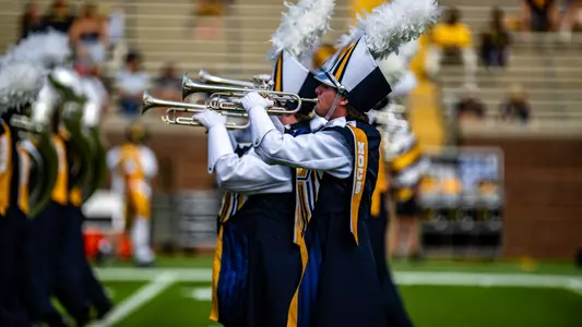 Profile view of the the trumpet section as they, well trumpet, during the Marching Mocs perform at halftime of the win over ETSU in 2025.