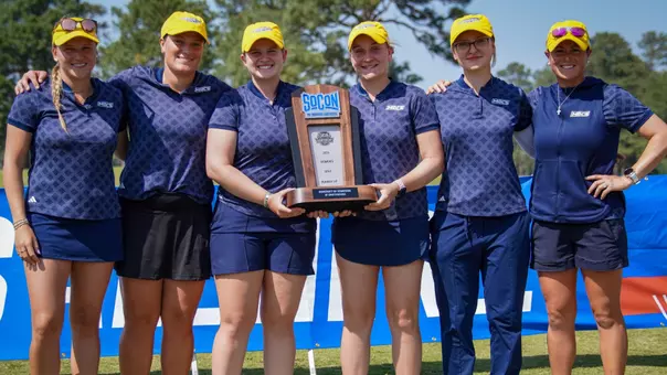 Team picture of women's golf with 2026 SoCon Championships runner-up trophy