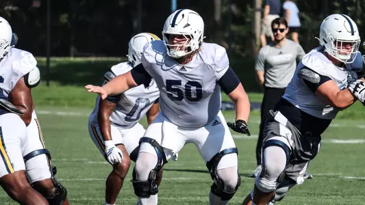 Devin Lively sits back in his pass blocking zone during fall camp.