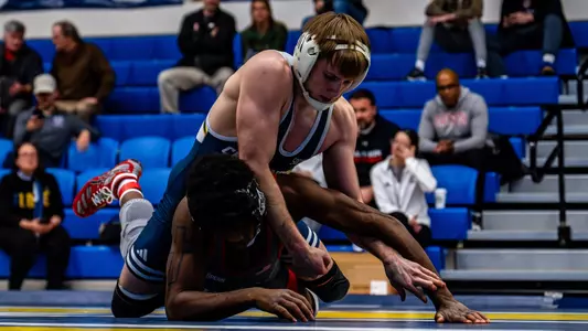 Hunter Mason is in dominant position on top staying high and controlling his opponent's wrists as he's face down on the mat.