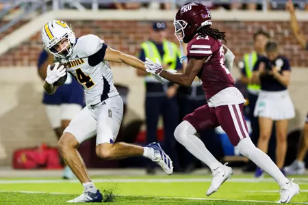 Ashton Schumann breaks a tackle