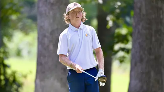 Camden Braidech holds his driver waist high pointing toward his target in the fairway as part of his pre-shot routine.